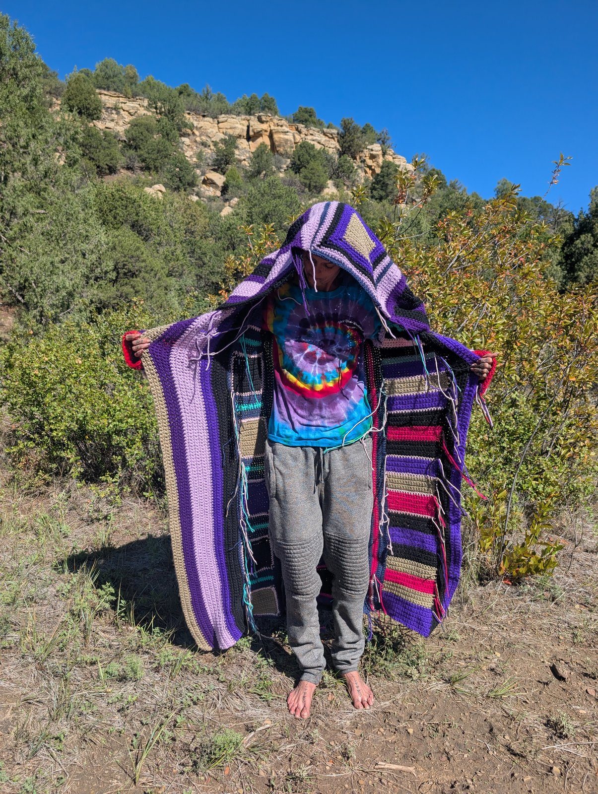 Hooded granny-square coat worn open, front view