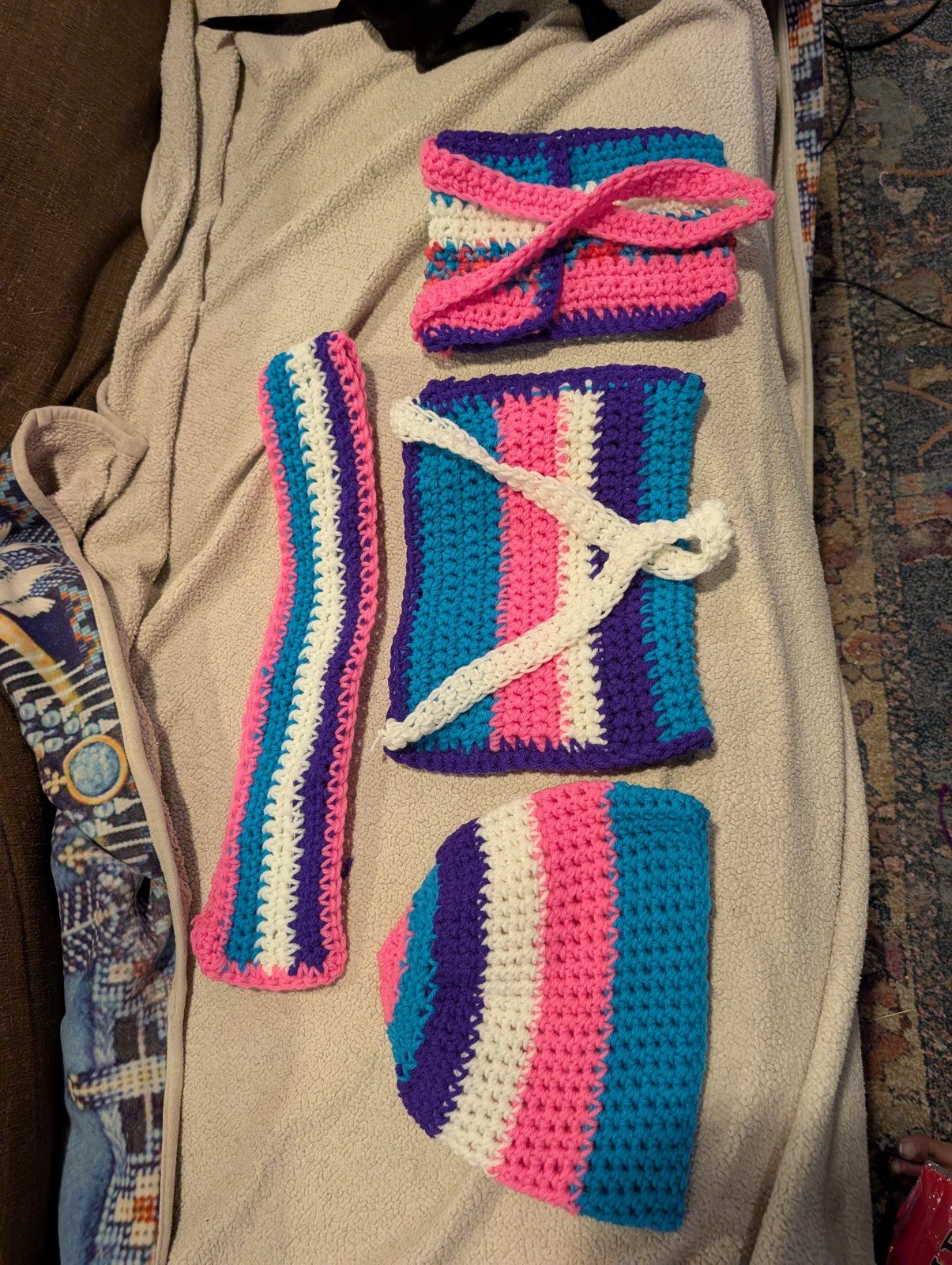 Pink and teal crochet set laid out flat